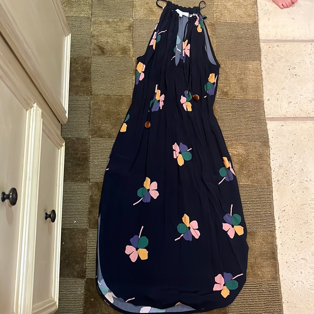 Navy floral tie neck, tea length dress. Flirty side slits & adjustable neckline
